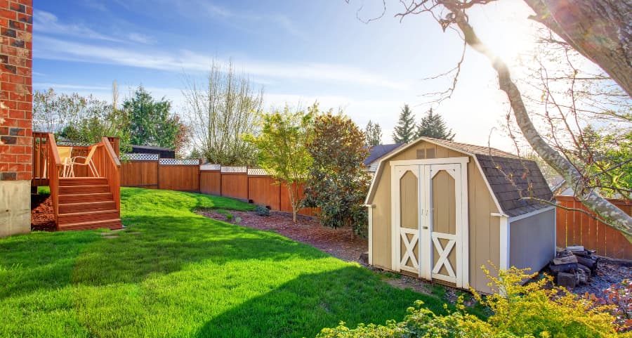 Fenced backyard with storage shed in Manchester